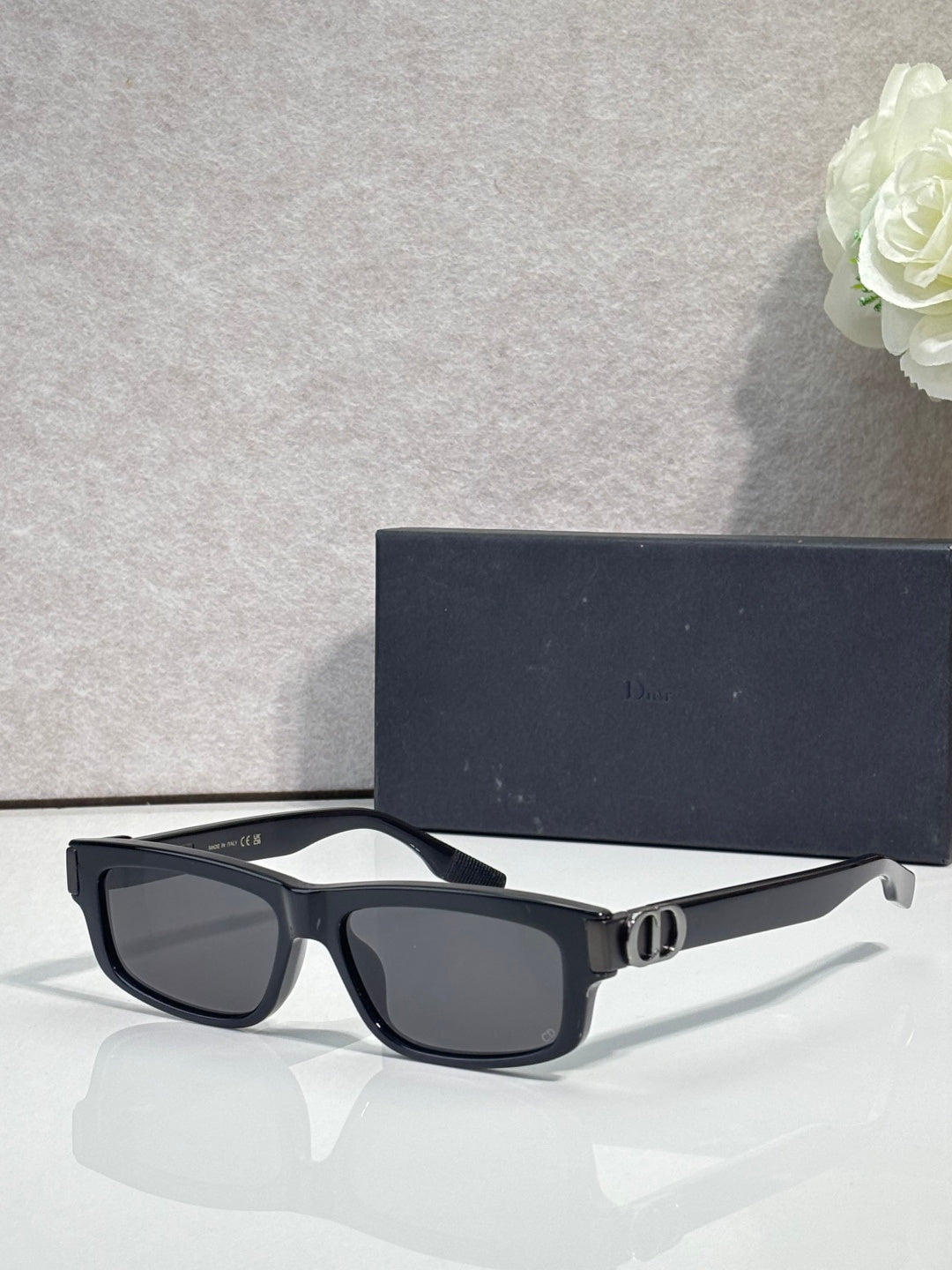 Dior black rectangular sunglasses with dark lenses and metal logo hinge