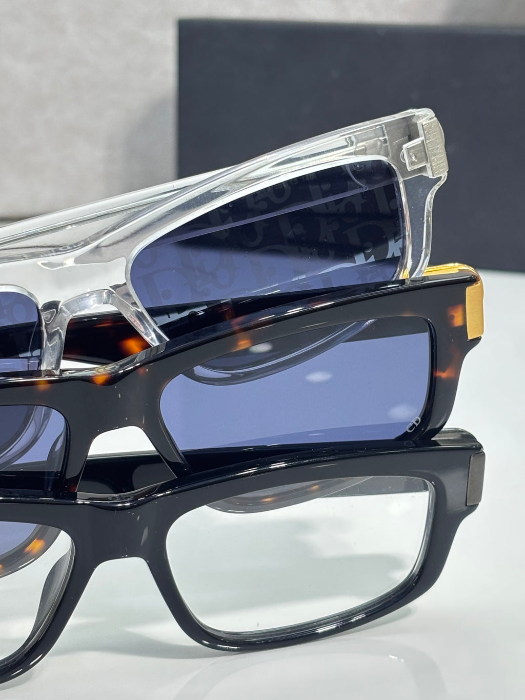 Dior glasses with clear acetate temple tips and dark blue-tinted lenses