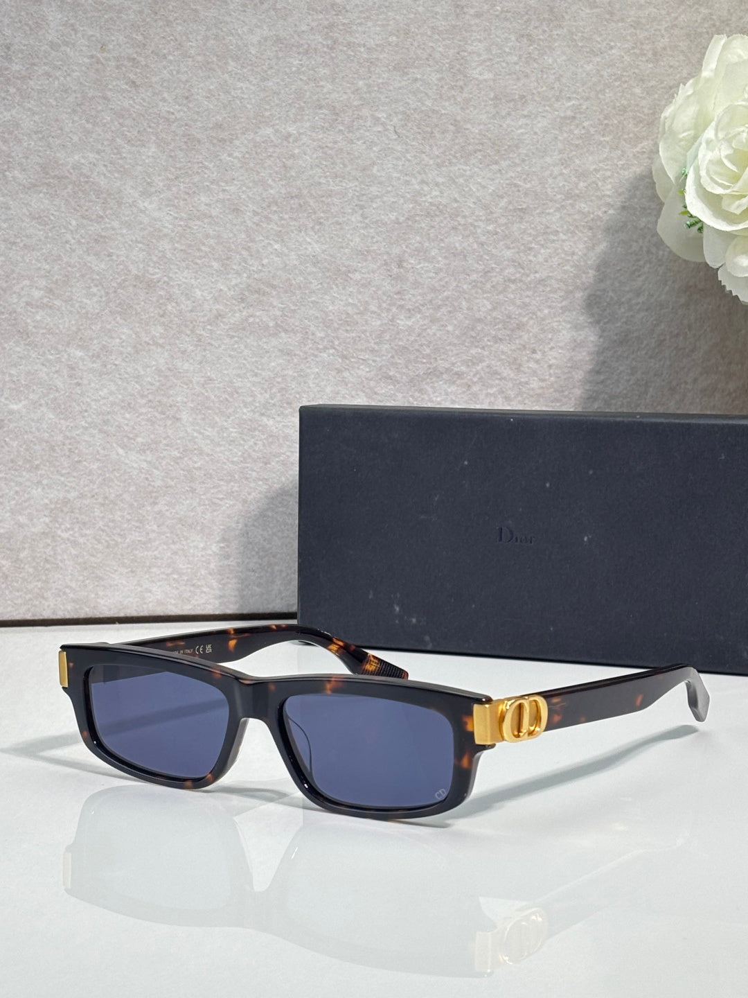 Dior black tortoiseshell acetate sunglasses with dark lenses and gold logo hinge
