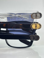 Dior stacked eyeglasses showing blue lenses and metal logo hinge details
