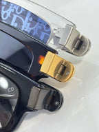 Dior glasses close-up: gold hinge and temple with blue patterned lining.