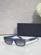 Dior glasses with blue frame, dark lenses, and gold bridge detail.