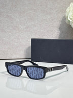 Dior glasses with dark blue patterned lenses and black frame, gold bridge.