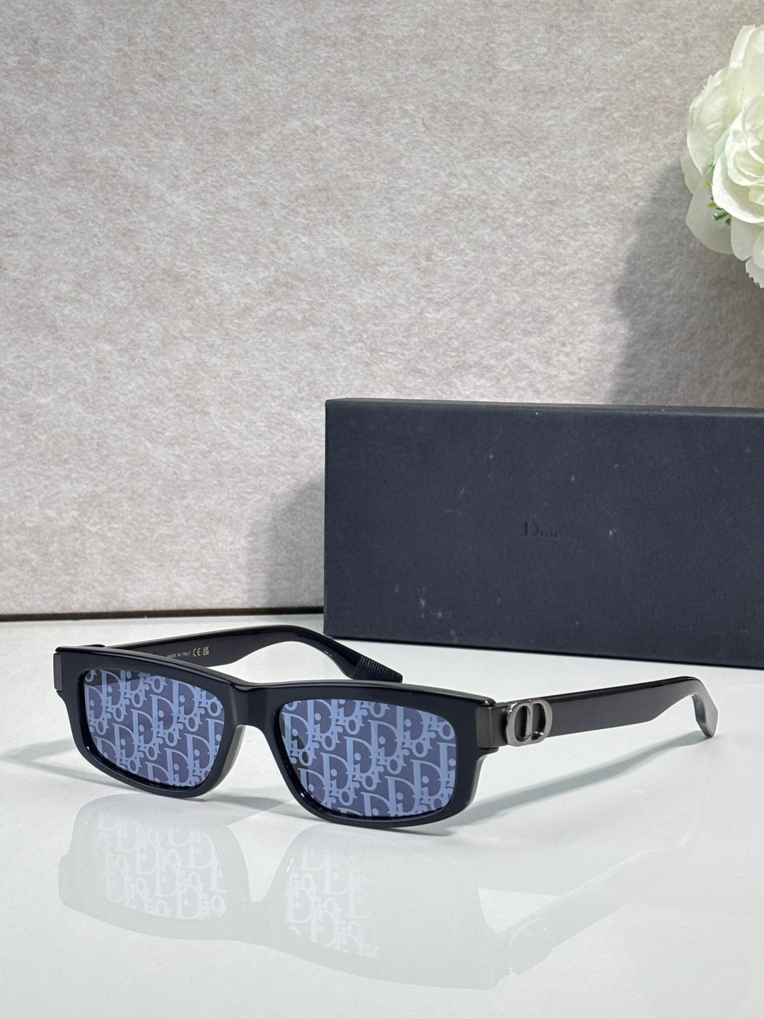 Dior glasses with dark blue patterned lenses and black frame, gold bridge.