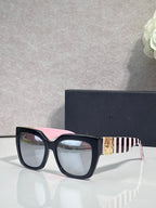 Dior glasses with dark frames, pink-striped temple detail, and clear lenses
