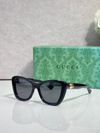 Designer eyeglasses with dark navy frames and dark tinted lenses