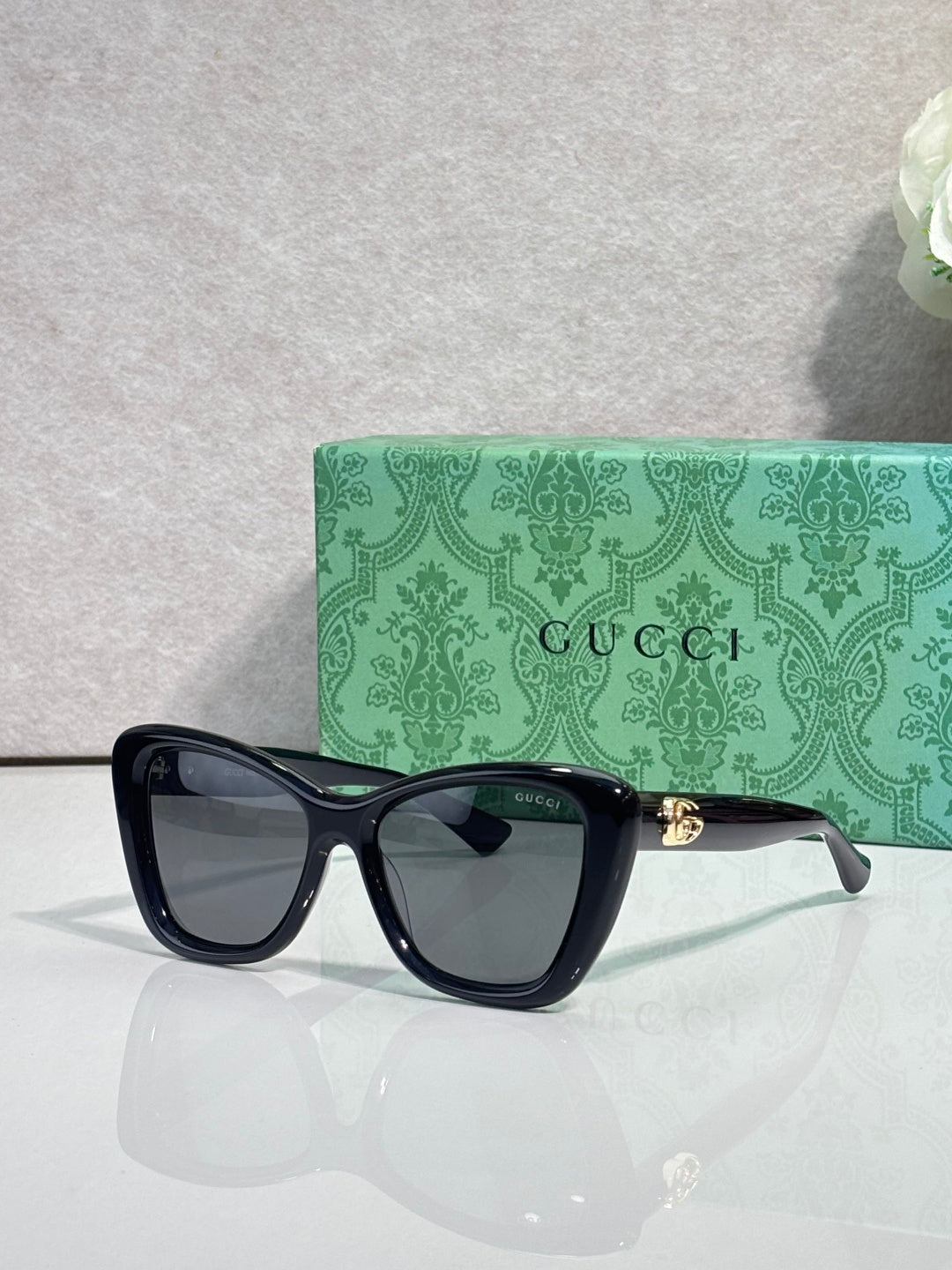 Designer eyeglasses with dark navy frames and dark tinted lenses