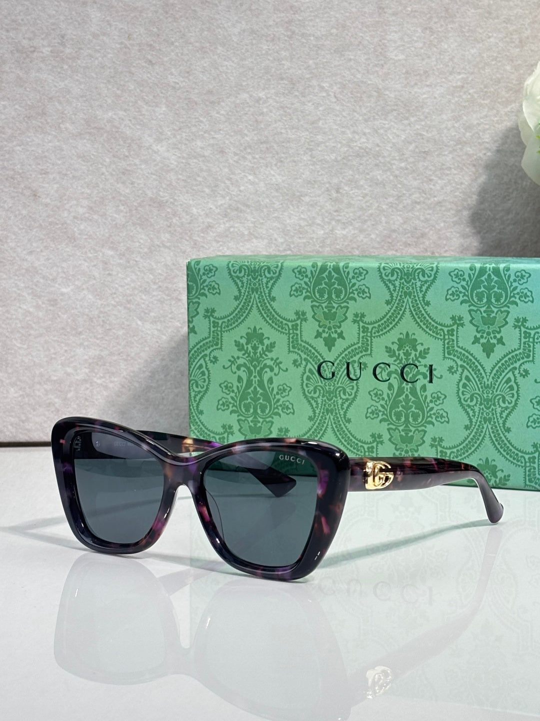 Designer eyeglasses with dark navy frames and tinted lenses