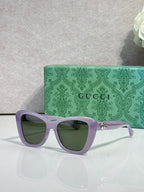 Designer eyeglasses with lavender frames and green-tinted lenses