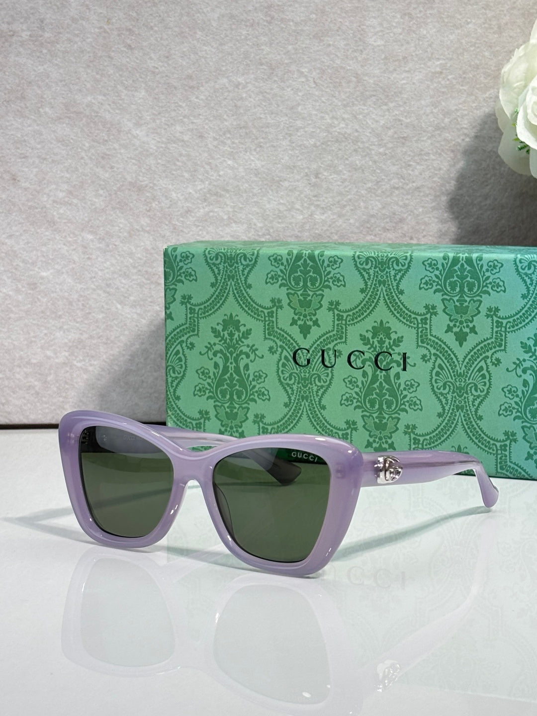 Designer eyeglasses with lavender frames and green-tinted lenses