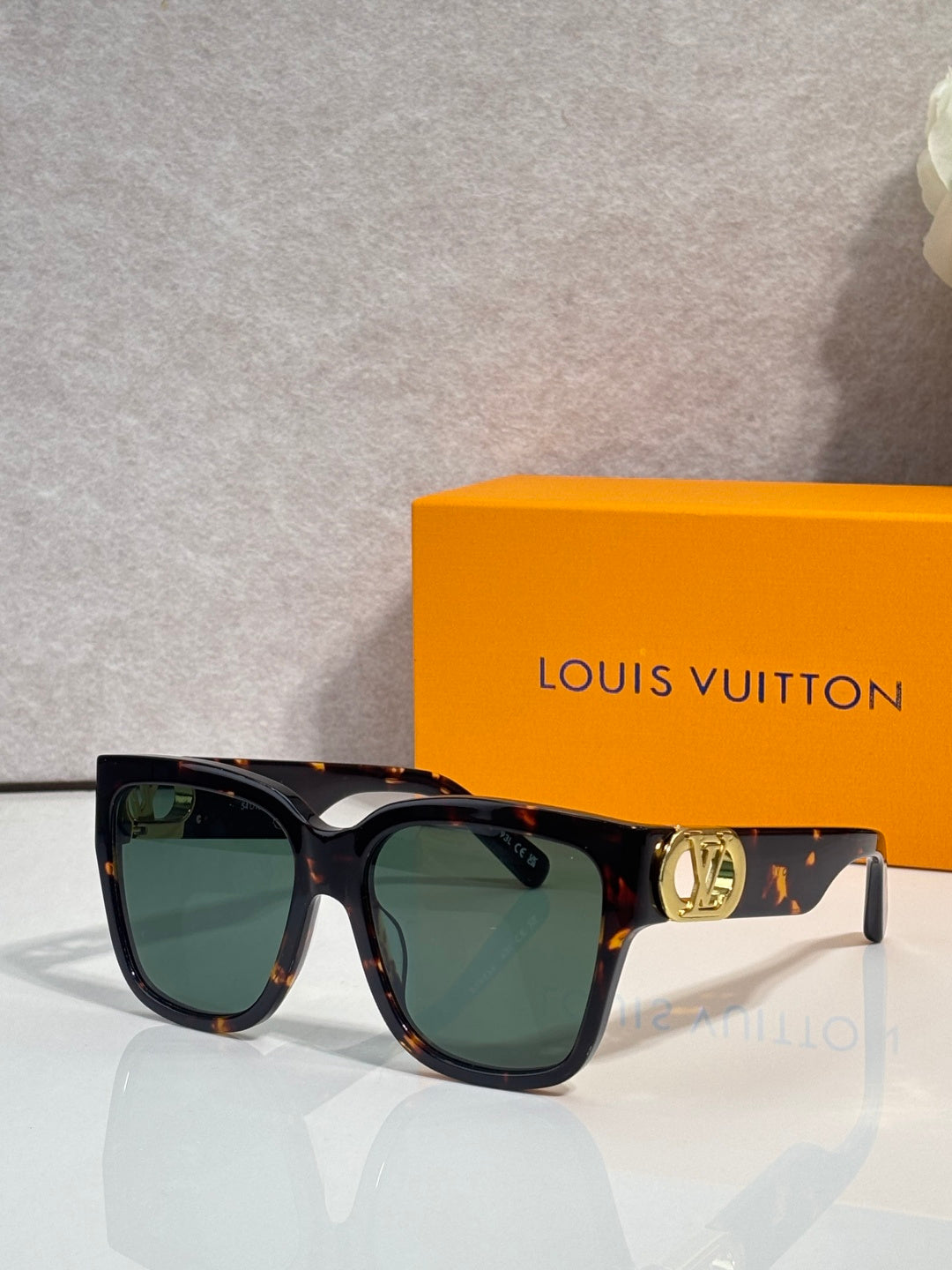 Louis Vuitton sunglasses, dark tortoiseshell frame, green lenses, gold LV temple hardware