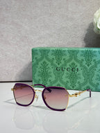 Gucci glasses with gradient purple tinted lenses, dark frame with gold hinge detail