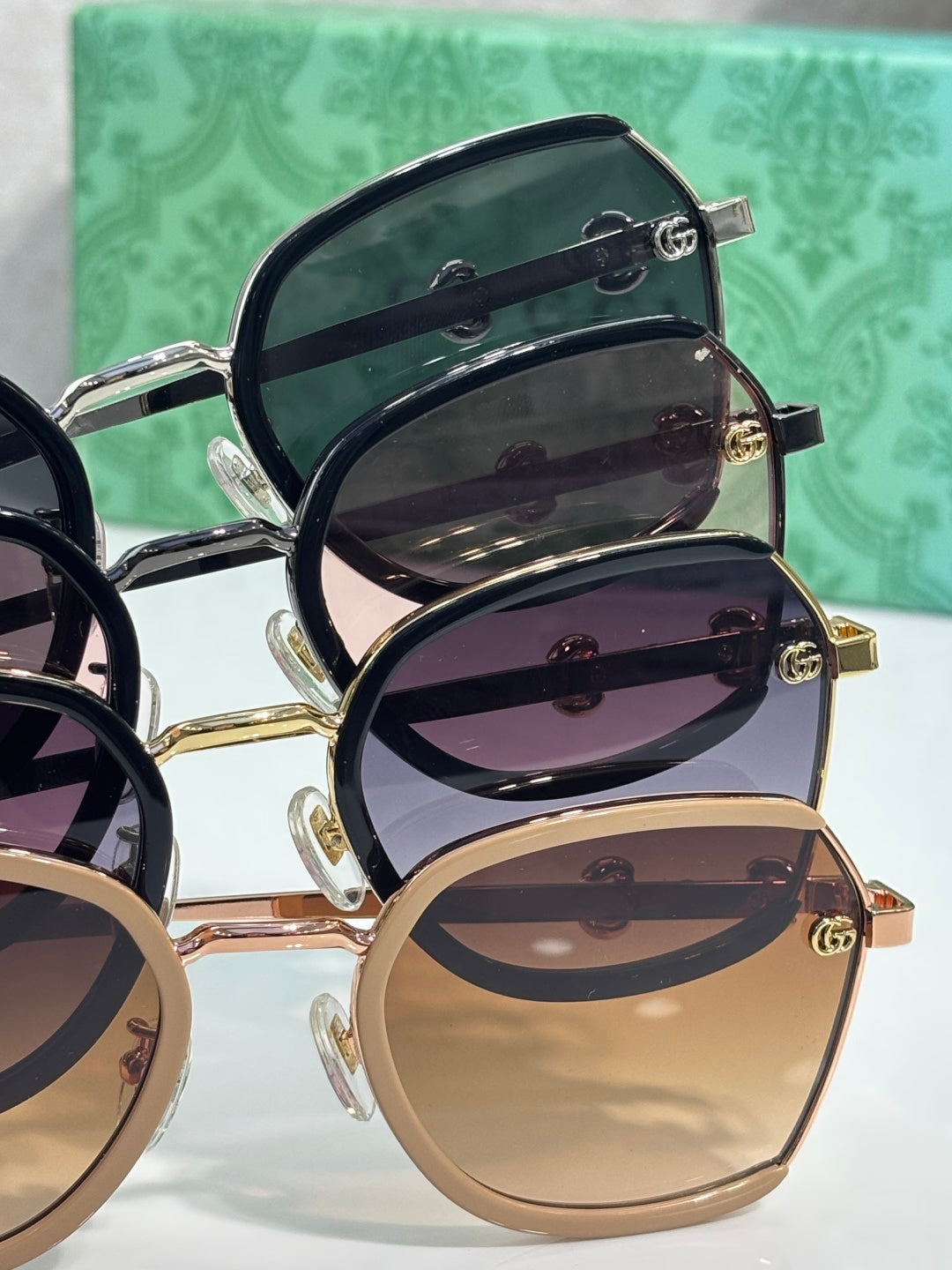 Gucci glasses detail: stacked round frames with dark, purple, and tan tinted lenses