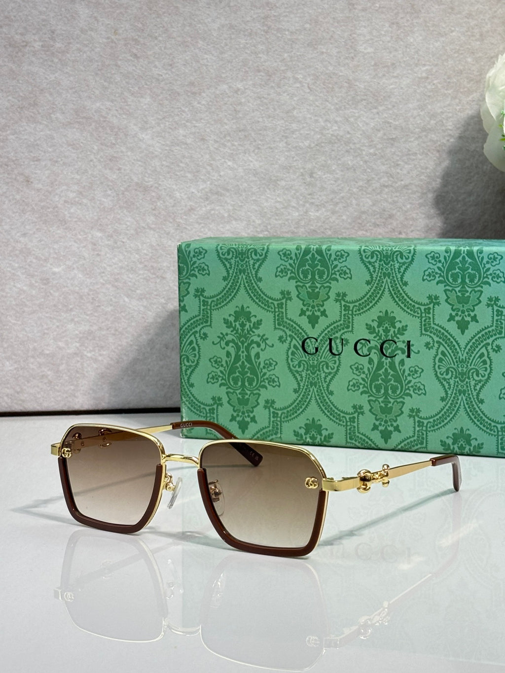 Gucci sunglasses with dark brown square frames and warm brown gradient lenses