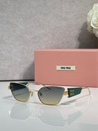 MiuMiu sunglasses with gold frame and dark green lenses