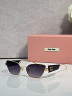MiuMiu sunglasses with gold frame and dark navy lenses