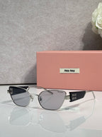 MiuMiu sunglasses with silver-toned frame and smoke lenses