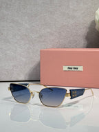 MiuMiu sunglasses with gold frame and blue-tinted lenses