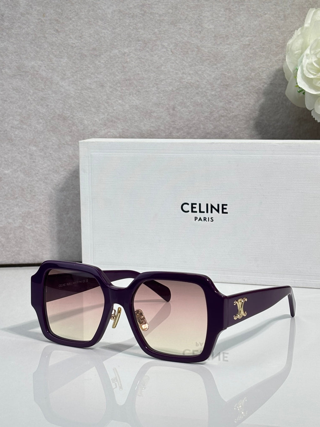 Purple rectangular sunglasses with pale gradient lenses and gold logo on the temple