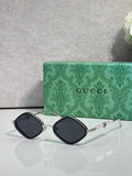 Gucci sunglasses with dark lenses and silver metal frames, arched square style