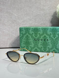 Gold oval sunglasses with gradient green lenses and decorative chain-link arms