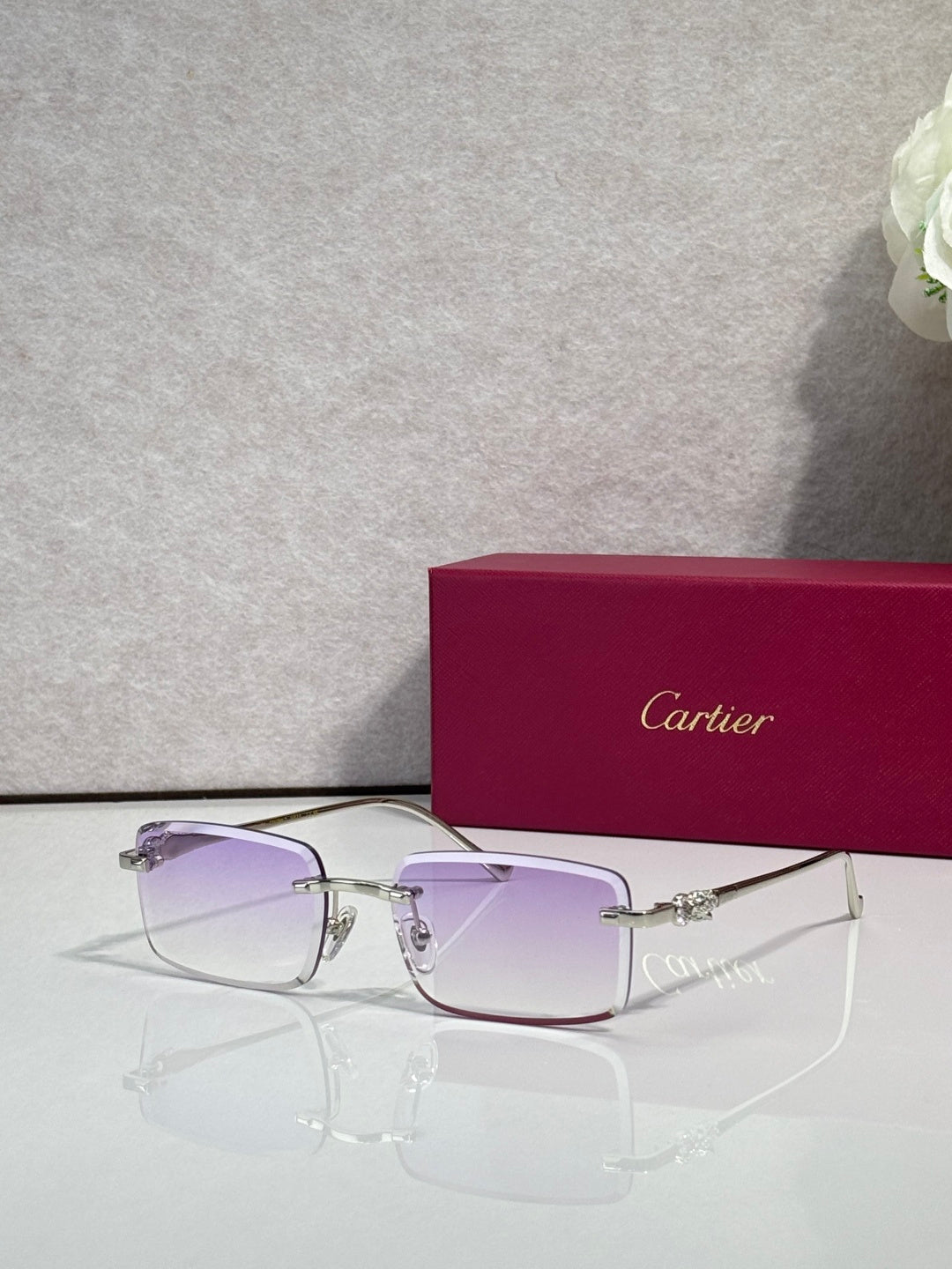 Cartier eyeglasses with gold frame and purple-tinted square lenses