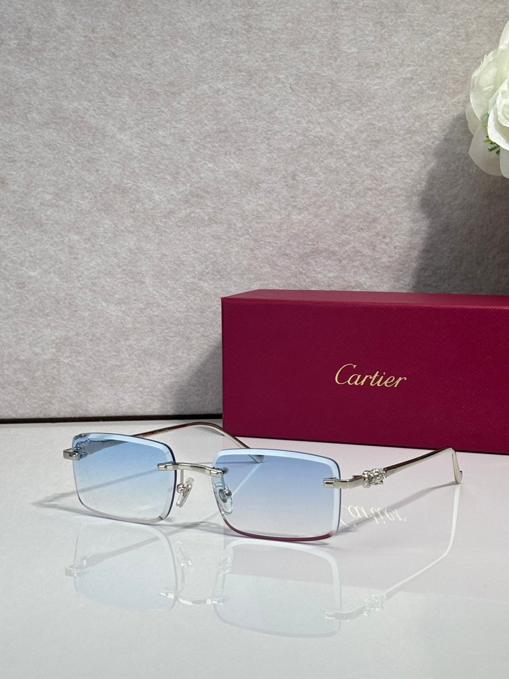 Cartier eyeglasses with gold frame and light blue-tinted square lenses