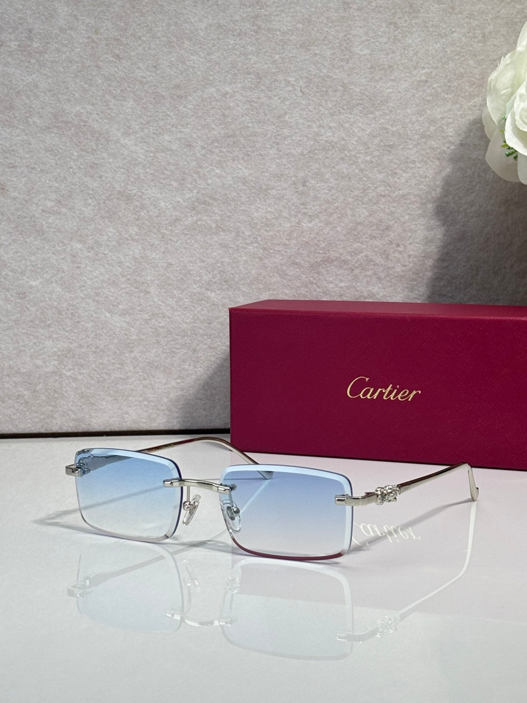 Cartier eyeglasses with gold frame and light blue-tinted square lenses