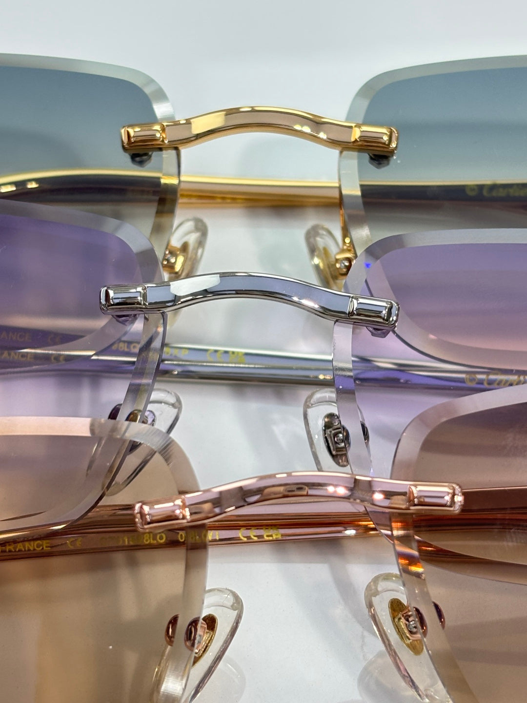 Cartier glasses close-up with blue-tinted lenses and mixed metal frames