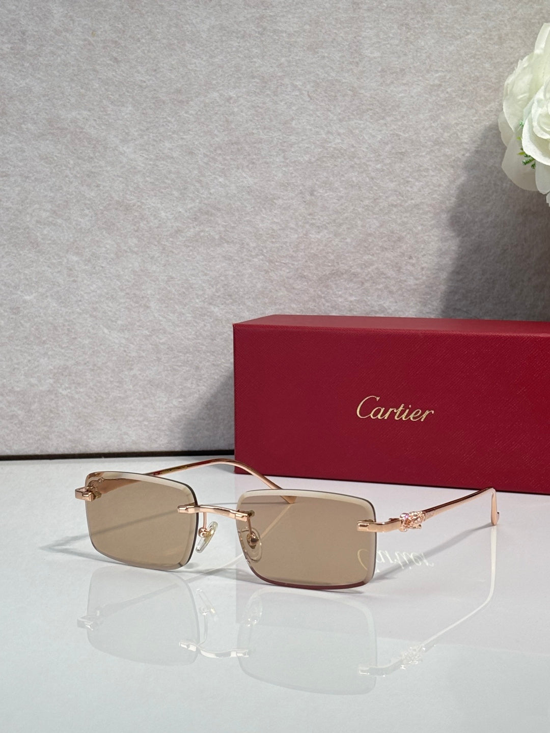 Cartier glasses with gold frame and warm taupe gradient lenses, square silhouette