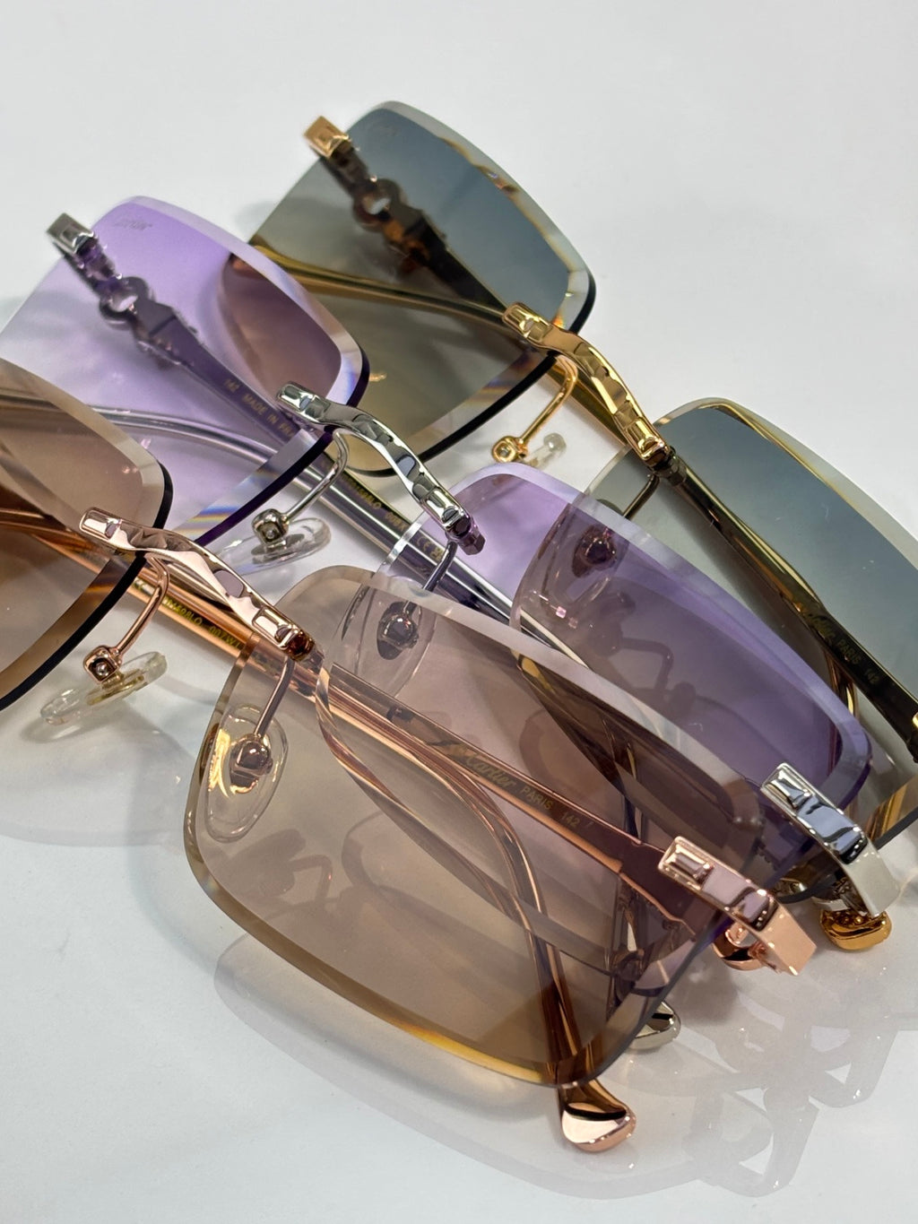Cartier glasses angled view with purple tint lenses and gold metal rims
