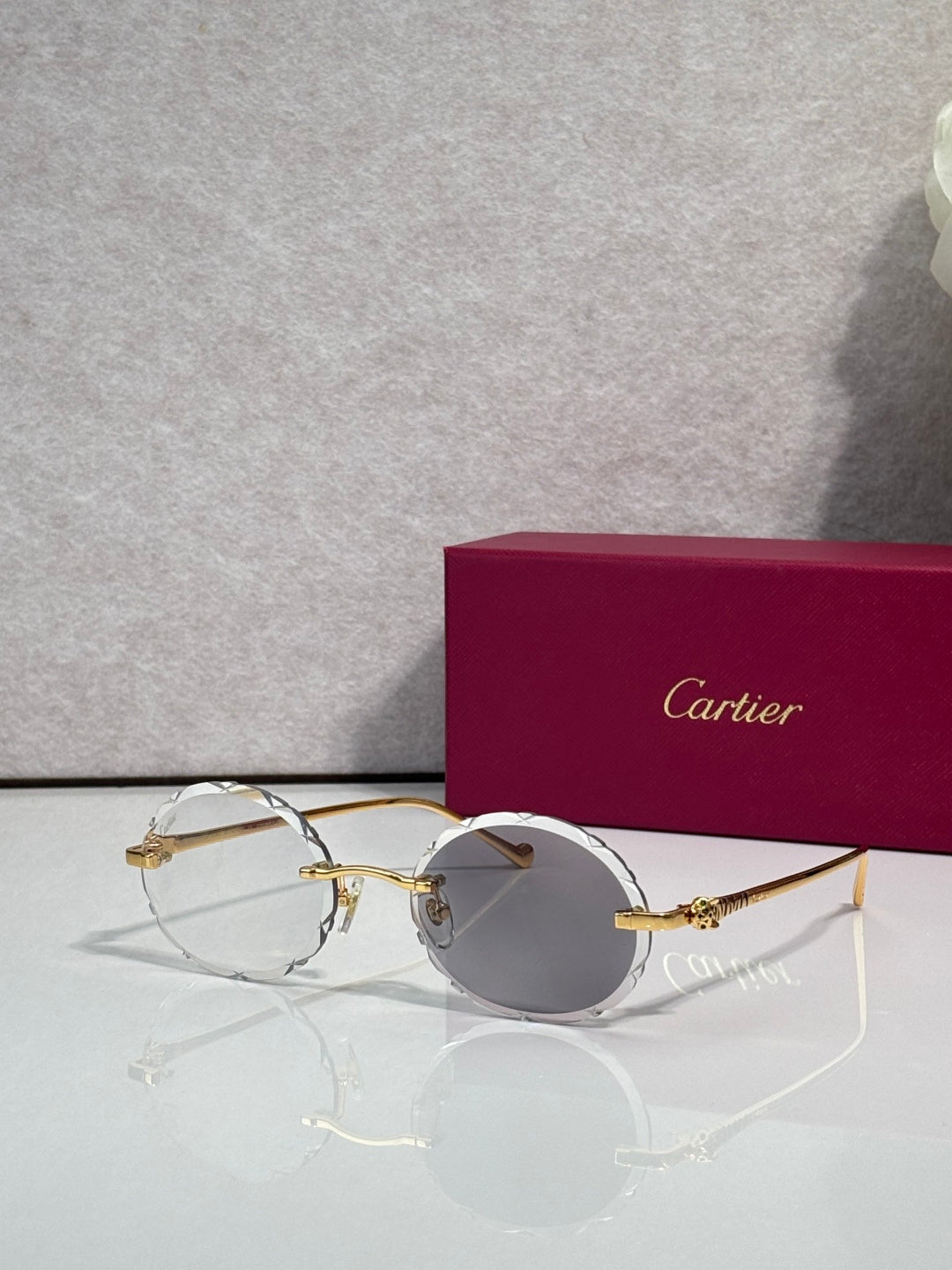 Cartier round eyeglasses with gold-tone metal frame and clear lenses