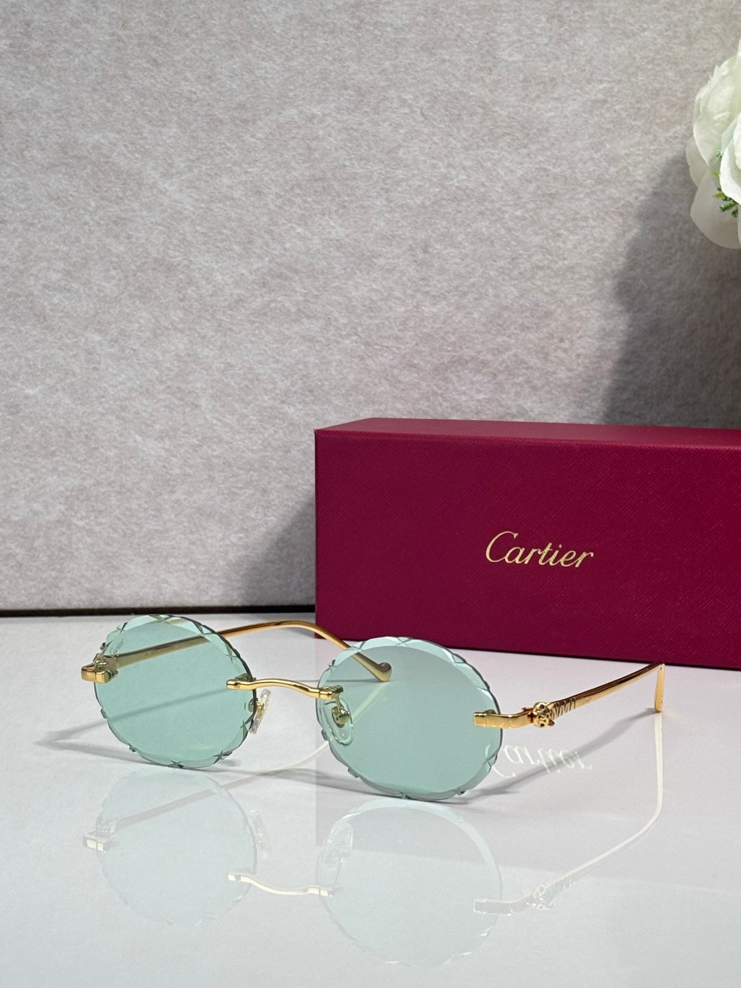 Cartier round eyeglasses with gold-tone frame and green-tinted lenses