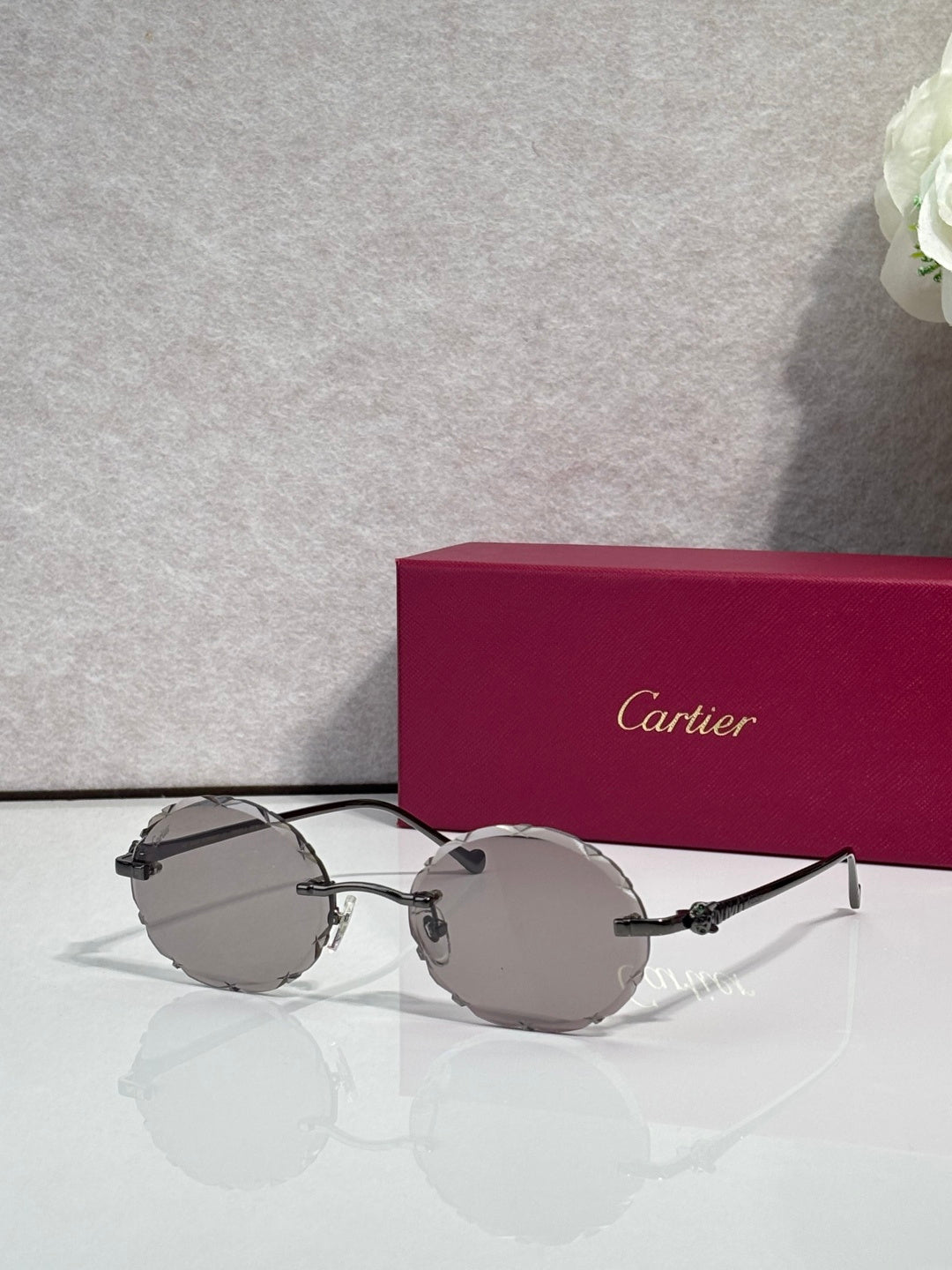 Cartier round sunglasses with dark frame and gray tinted lenses