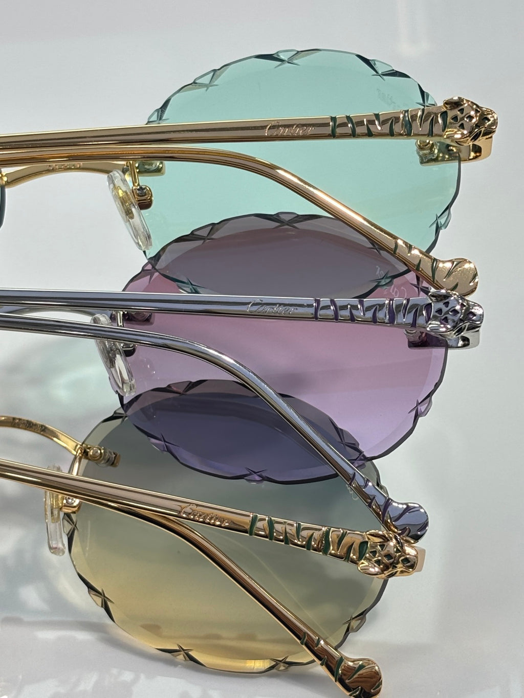 Cartier sunglasses stack: gold frame with mint and purple tinted lenses