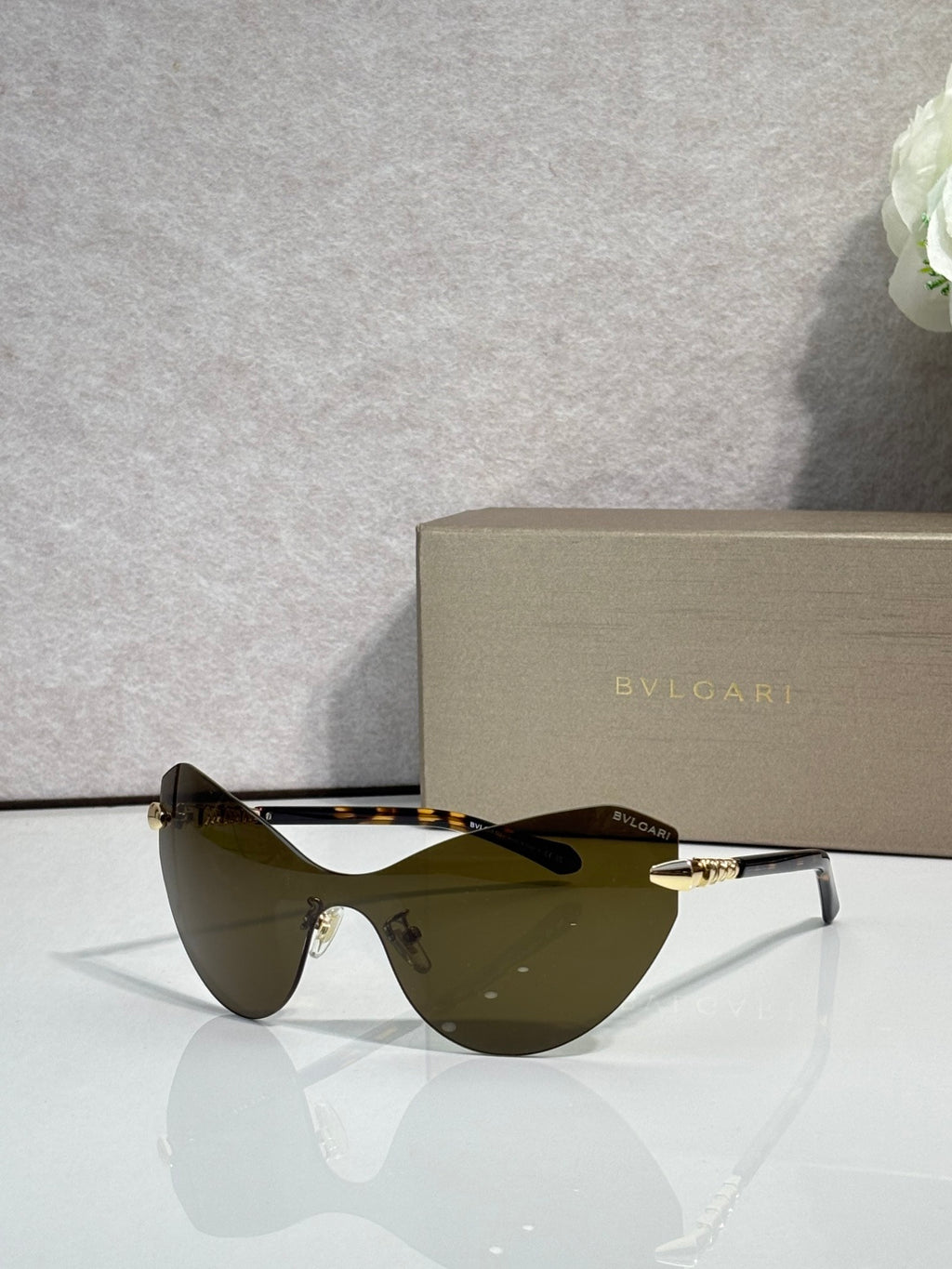 Bvlgari cat-eye sunglasses with olive-tinted lenses and gold-tone temple hardware