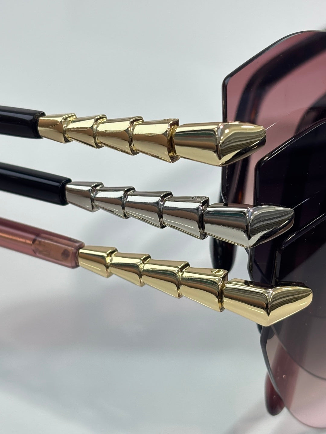 Bvlgari sunglasses temple close-up with gold-tone and silver-tone segments