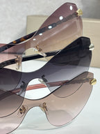 Bvlgari cat-eye sunglasses stacked together, showing tinted lenses and gold details