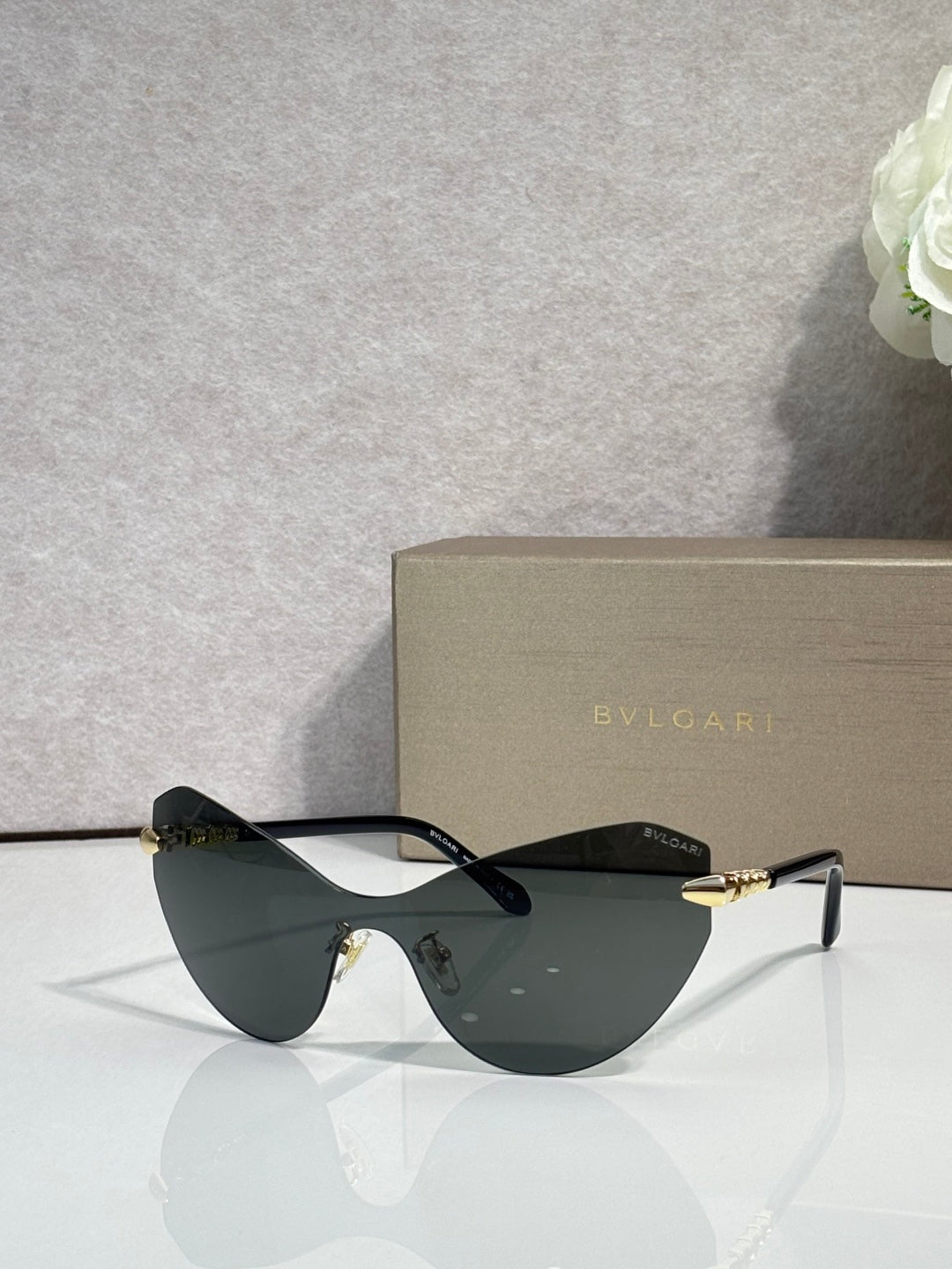 Bvlgari cat-eye sunglasses with dark lenses and gold-tone accents on temples