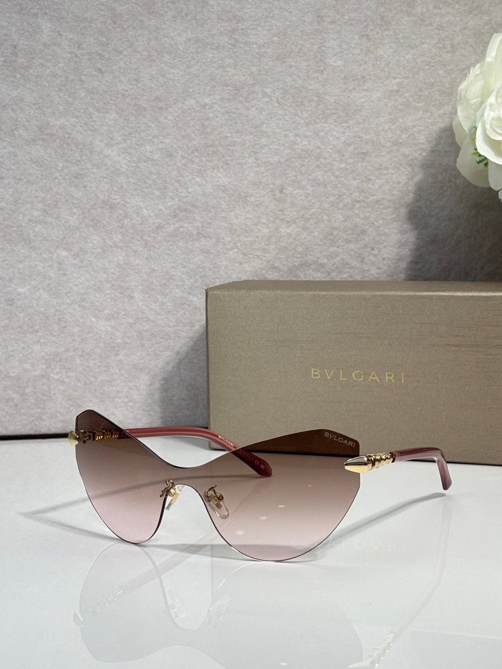 Bvlgari cat-eye sunglasses, pink-tinted lenses, gold-tone temples