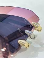Bvlgari sunglasses close-up, tinted lens edge with gold-tone hinge hardware