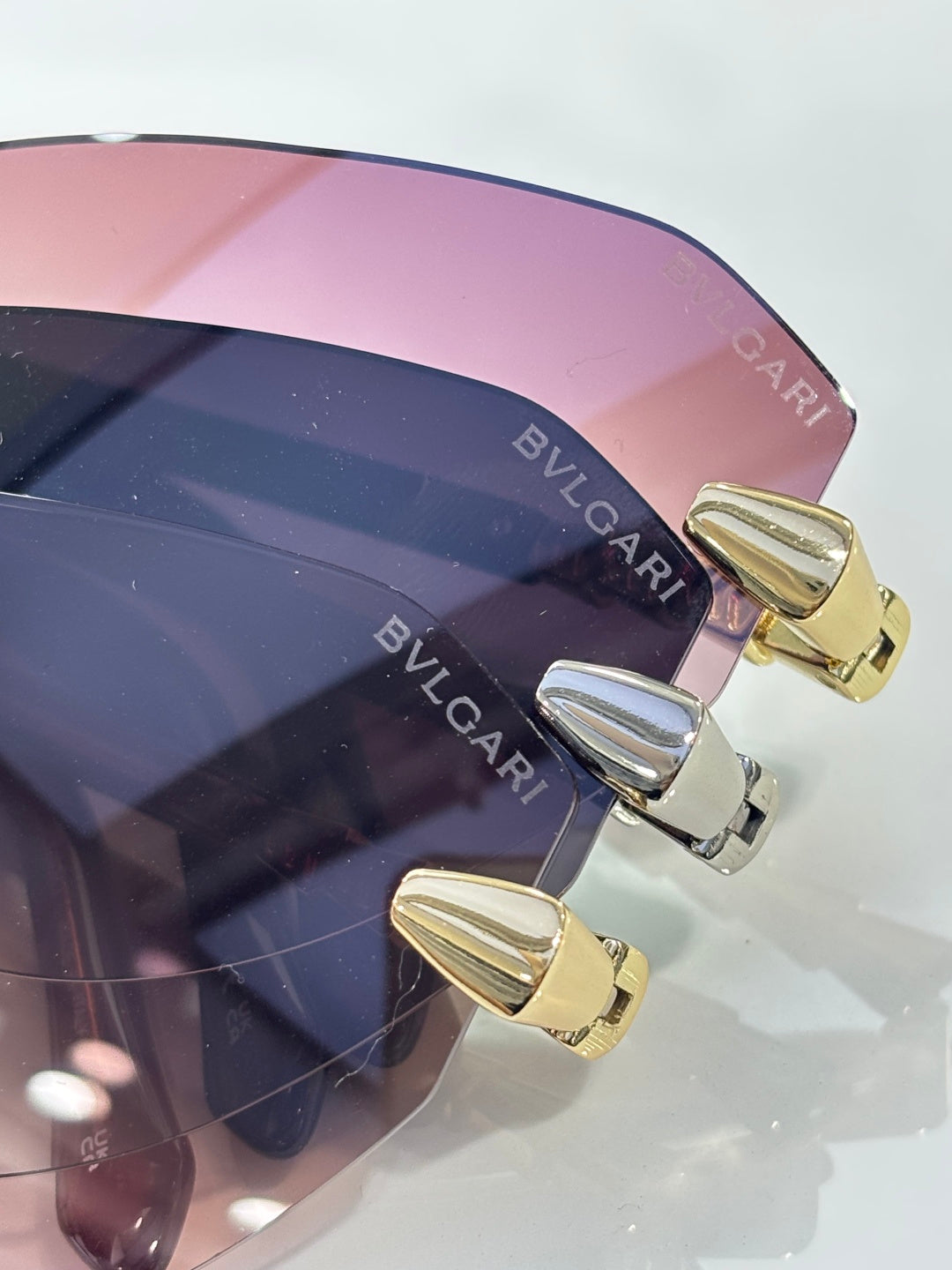 Bvlgari sunglasses close-up, tinted lens edge with gold-tone hinge hardware