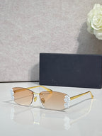 Dior sunglasses with amber lenses and gold frame, white flower accents on temples