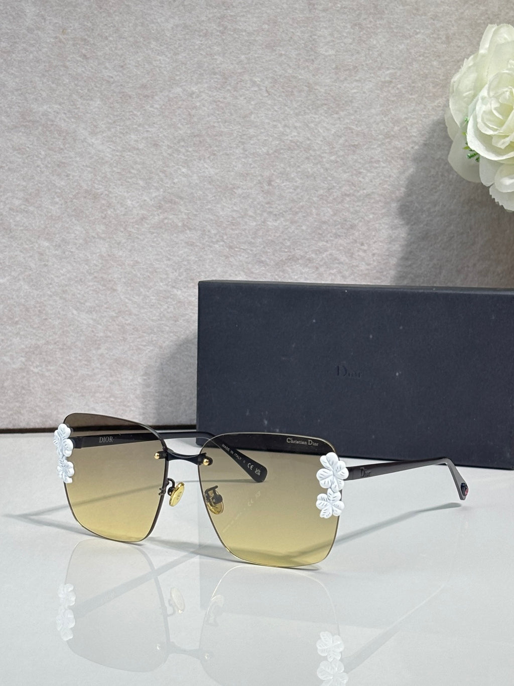 Dior sunglasses, gold frame, dark temples, yellow gradient lenses, light blue floral details