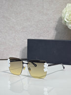 Dior sunglasses, gold frame, dark temples, yellow gradient lenses, light blue floral details