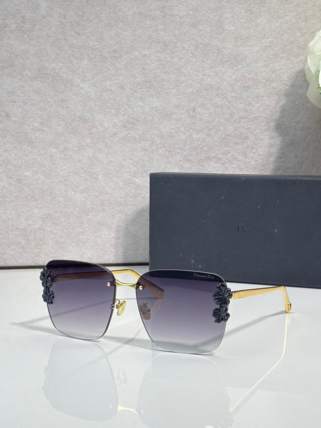 Dior sunglasses, gold frame, dark temples, lavender gradient lenses, dark floral accents