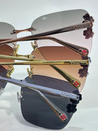 Dior sunglasses close-up, gold and dark frames, tinted lenses, floral temple details