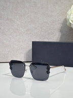 Dior sunglasses, gold frame, black temples, dark gradient lenses, dark floral accents