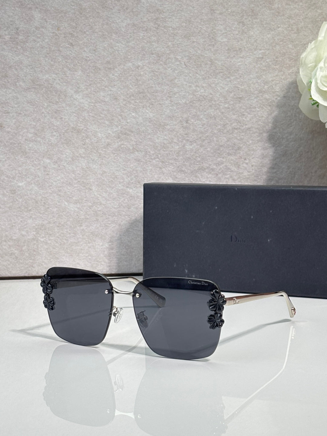 Dior sunglasses, gold frame, black temples, dark gradient lenses, dark floral accents