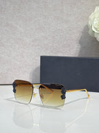 Dior sunglasses, gold frame, dark blue temples, yellow gradient lenses, floral accents